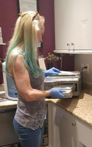 Julie Green, Manager/Piercer, working in the clean room at Westcoast Piercing and Ink